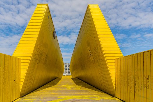 Rotterdam, Netherlands, September 2019: view on the Luchtsingel, a crowdfunded elevated wooden yellow foot bridge, connecting park pompenburg, hofplein and dakakker