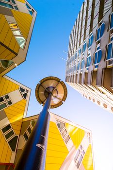 Low angle view of the Cube houses (Kubuswoningen) and Blaaktoren (Het Potlood) architecture, both designed by architect Piet Blom