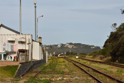 Building and railroad at the old Groot Brakrivier train stop, Mossel Bay, South Africa