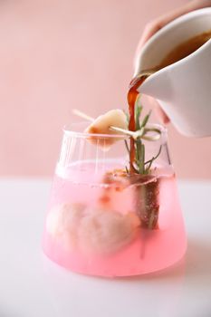 lychee juice with coffee in pink background