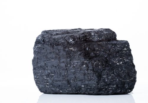 large piece of black bituminous coal on a white background