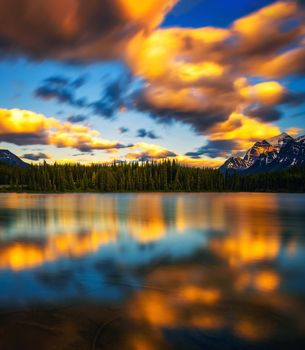Scenic sunset over Herbert Lake along the roadside of the Icefields Parkway in Banff National Park, Alberta, Canada. Long exposure.