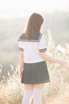 Portrait of asian japanese school girl costume looking at park outdoor film vintage style