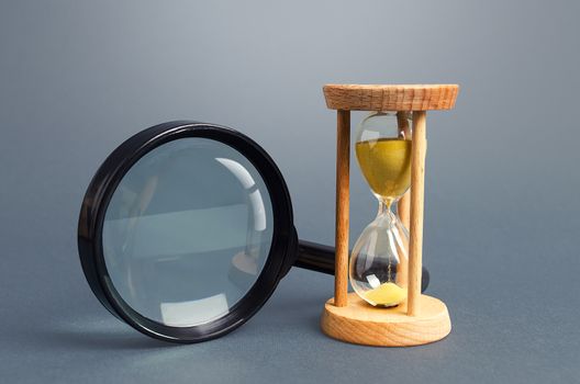 Magnifying glass and hourglass. Limited Search Concept. Find free time. Subscription, paid plan. Seek in short time. Speed and efficiency. Deadline