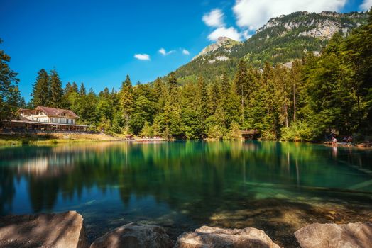 Mountain lake Blausee located in the Kander valley above Kandergrund in the Jungfrau region. Long exposure.