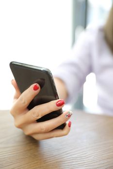 Woman hand using smart phone in business