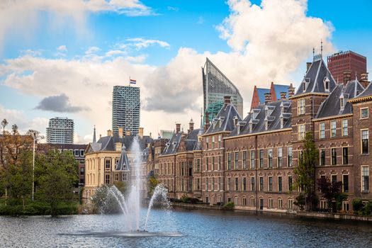 Binnenhof palace complex with pond and fountain in the foreground and business district in the background, The Hague, Netherlands