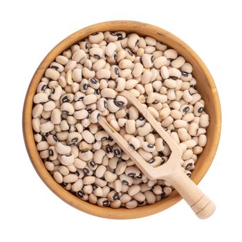 Black-eyed peas in a wooden bowl isolated on a white background.