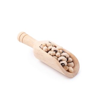 Black-eyed peas in a wooden bowl isolated on a white background.