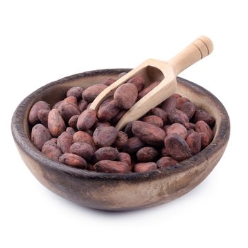 Cocoa fruit in a wooden bowl, raw cacao beans isolated on a white background.