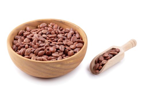 pinto beans in a wooden bowl isolated on a white background.