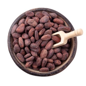 Cocoa fruit in a wooden bowl, raw cacao beans isolated on a white background.