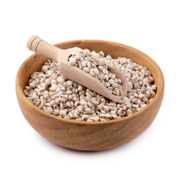 Millet rice in a wooden bowl isolated on white background.