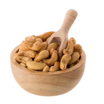 Closeup of cashew nuts in a wooden bowl isolated on white background.