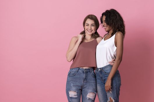 Happy smiling beautiful girl friend hug and wearing casual comfortable shirts isolated on pink background.