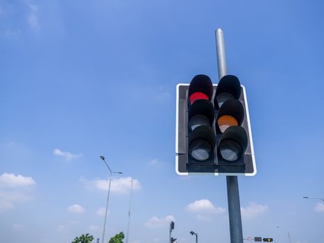 the traffic lights against a vibrant blue sky