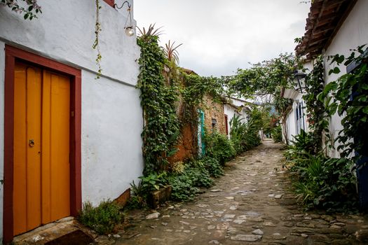 Old town street with flowers on the walls