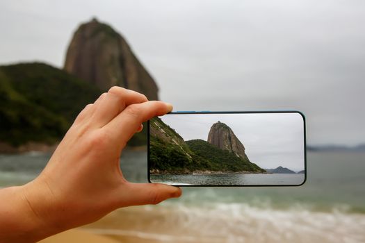 Photographing a Sugar Loaf mountain on a smartphone, Rio-de-Janeiro