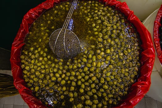 A bucket of green olives at a local street market