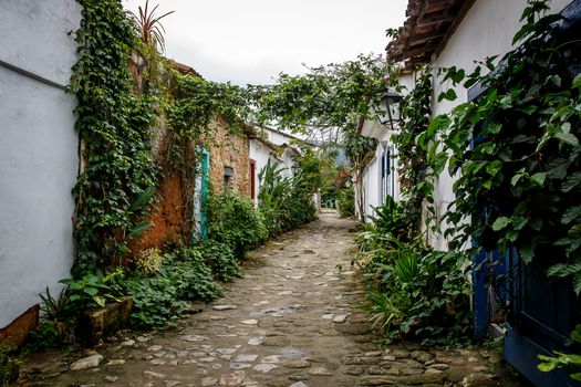 Old town street with flowers on the walls