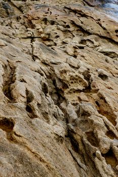 Texture of coastal old stone. Rock wallpaper