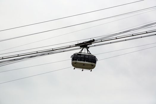 Cabin cableway on a background of cloudy sky