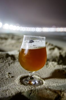 A glass of beer at Copacabana Beach in Rio De Janeiro, Brazil. Night lighting.