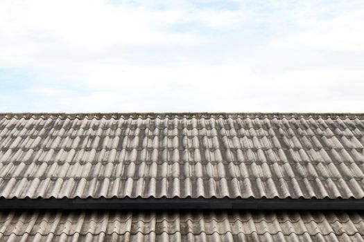 roof wavy tile, roofing tile old, white or grey roofing tile old on sky background