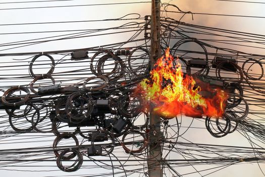 Fire is burning at High Voltage Cables power, Danger wire tangle cord electrical energy