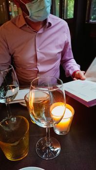 Man reading menu at the restaurant during Coronavirus pandemic.