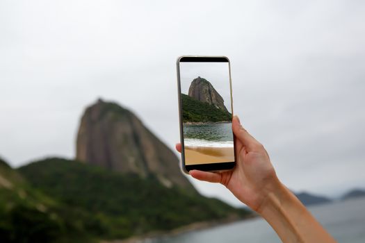 Photographing a Sugar Loaf mountain on a smartphone, Rio-de-Janeiro