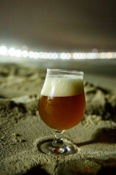 A glass of beer at Copacabana Beach in Rio De Janeiro, Brazil. Night lighting.