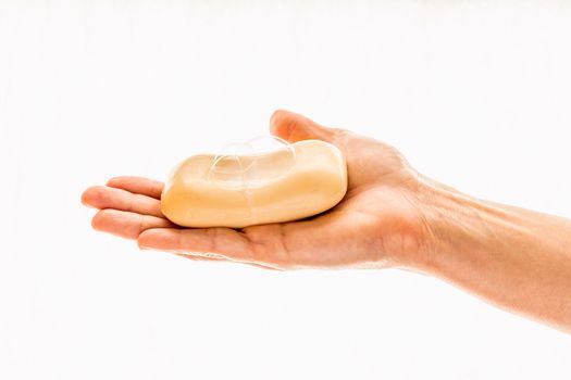 A human hand showing a soap with bubbles.