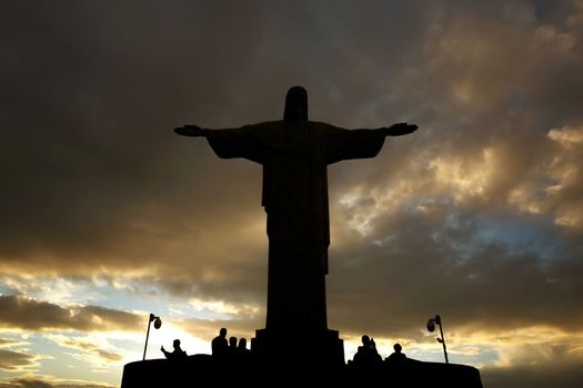 Rio de Janeiro, Brazil - 21.11.2019: Black silhouette of Christ statue. Cross on sunset sky
