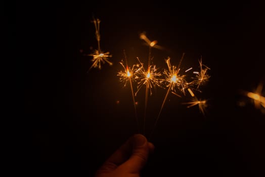 Sparkler fireworks being lit in the dark