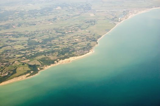 Aerial view of the coast at Sussex with Fairlight in the foreground stretching to Winchelsea and Camber Sands in the distance.  