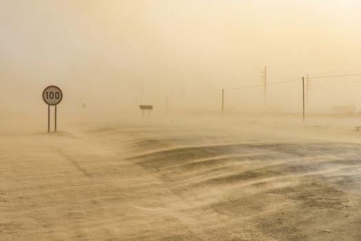 Sandstorm covering the road from Swakopmund to Walvis Bay in Namibia in Africa.