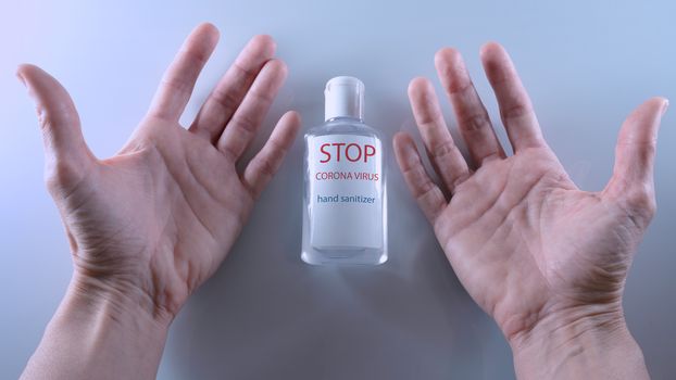 Using a bottle of hand sanitizer against Corona virus.