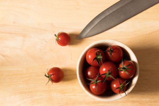 Fresh tomatoes in a plate on wooden  background