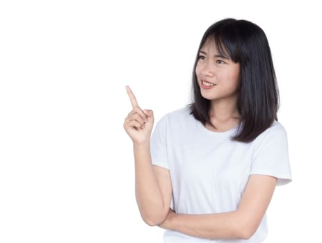 Smiling asian woman pointing up and looking at the camera isolated on white background