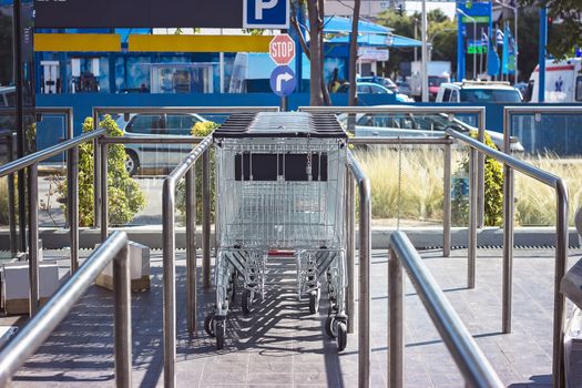 Row of empty shopping carts in front of supermarket