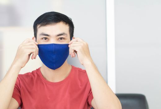 Closeup asian man wearing face mask for protect air polution or virus covid 19, health care and medical concept