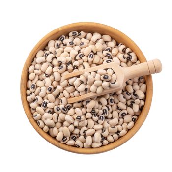 Black-eyed peas in a wooden bowl isolated on a white background.