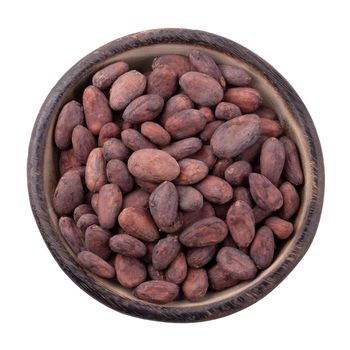 Cocoa fruit in a wooden bowl, raw cacao beans isolated on a white background.