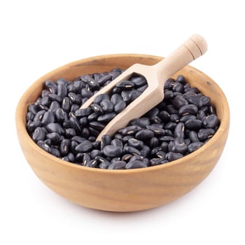 Black bean in a wooden bowl isolated on white background.
