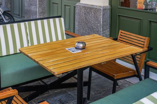 Restaurant outdoor table with menu and social media QR scan barcode after government loosens COVID-19 measures.