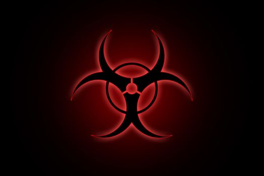 Biohazard sign on black background in red glow
