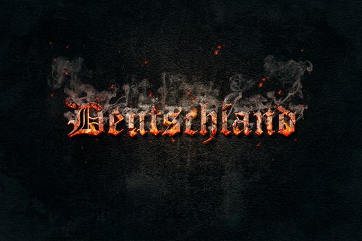 Image of burning text With the word Germany on a black concrete wall