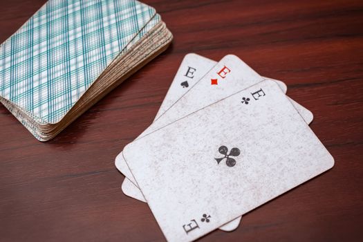 Play cards, three aces and a deck on the table. Card Solitaire