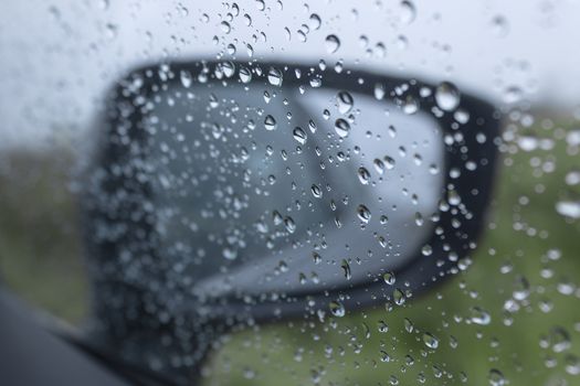 Raindrops on the side window of the car